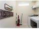 Bright laundry room with a modern washer and dryer and decorative 'Laundry' wall art at 3312 Lilac Wa, Davenport, FL 33897