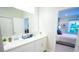 Bathroom featuring double vanity with modern fixtures and view to bright bedroom at 3927 Sagefield Dr, Harmony, FL 34773