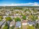 An aerial view showcasing a neighborhood with a variety of homes, mature trees, and connected streets at 4020 Shawn Cir, Orlando, FL 32826