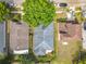 This aerial view displays the roof and yard of a house surrounded by mature trees and neighboring homes at 4020 Shawn Cir, Orlando, FL 32826