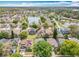 This aerial view captures a neighborhood near a lake, showcasing a mix of homes, trees, and roadways at 4020 Shawn Cir, Orlando, FL 32826