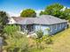 This aerial view shows the home's exterior, landscaping, screened-in lanai, and roof at 4020 Shawn Cir, Orlando, FL 32826