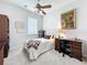 Bedroom with a ceiling fan, desk, bookcase, and a window for natural light creating a cozy space at 4020 Shawn Cir, Orlando, FL 32826