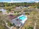 An aerial view shows a community pool area with a playground, seating, and a clear blue pool at 4020 Shawn Cir, Orlando, FL 32826