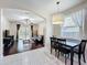 Bright dining area with tile flooring, pendant lighting, and seamless flow into the adjacent living room at 4020 Shawn Cir, Orlando, FL 32826