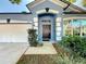 Charming single-story home with a blue exterior, a two-car garage, and a beautifully landscaped front yard at 4020 Shawn Cir, Orlando, FL 32826