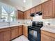 Well-lit kitchen featuring lots of cabinets, tile backsplash and floors, and appliances at 4020 Shawn Cir, Orlando, FL 32826