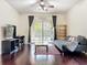 The hardwood floors and neutral walls give a light, airy feel to this living room with lanai access at 4020 Shawn Cir, Orlando, FL 32826