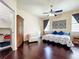 A view of the main bedroom featuring wood floors, a walk-in closet, and natural light at 4020 Shawn Cir, Orlando, FL 32826