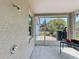 Outdoor shower in the enclosed lanai, complemented by a window and views of the green backyard at 4020 Shawn Cir, Orlando, FL 32826