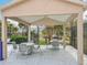 Covered outdoor seating area next to a pool, offering a place to relax and socialize in the community at 4020 Shawn Cir, Orlando, FL 32826