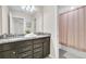 This bathroom features a granite countertop vanity with double sinks, a large mirror, and shower with curtain at 4058 Lana Avenue, Davenport, FL 33897