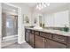 This bathroom features a double sink vanity with granite countertop and a glass-enclosed shower at 4058 Lana Avenue, Davenport, FL 33897