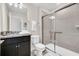 Modern bathroom featuring granite countertops, cabinets, and a glass-enclosed shower at 4058 Lana Avenue, Davenport, FL 33897