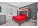 Bunk bedroom featuring gray decor, red bedding and a wall mounted television at 4058 Lana Avenue, Davenport, FL 33897