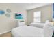 Comfortable bedroom featuring two twin beds, and a television for entertainment at 4058 Lana Avenue, Davenport, FL 33897