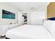 Bright bedroom featuring a TV, white dresser and closet, and bed with a navy blue headboard at 4058 Lana Avenue, Davenport, FL 33897