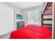 Bedroom featuring a bunk bed, red bedding and a wall mounted television at 4058 Lana Avenue, Davenport, FL 33897