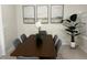 Elegant dining room with wooden table, gray chairs, and artwork enhancing the space at 4058 Lana Avenue, Davenport, FL 33897