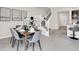 Dining area adjacent to the staircase and kitchen area, with a modern table setting at 4058 Lana Avenue, Davenport, FL 33897