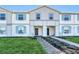 Charming townhome exterior with light blue shutters and well-manicured lawn at 4058 Lana Avenue, Davenport, FL 33897