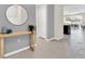 Inviting foyer featuring a round mirror, console table, and neutral color palette at 4058 Lana Avenue, Davenport, FL 33897