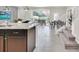 Kitchen island adjacent to the staircase, with the dining area and pool in the background at 4058 Lana Avenue, Davenport, FL 33897