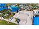 Aerial view of a beach volleyball court surrounded by palm trees and blue-roofed buildings at 4058 Lana Avenue, Davenport, FL 33897