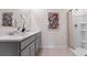 Bathroom featuring a double vanity with quartz countertop and a glass-enclosed shower with neutral color palette at 4212 Evernia Rd, Tavares, FL 32778