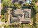 A beautiful aerial view of the house with its tile roof and screened-in pool at 470 Manor Rd, Maitland, FL 32751