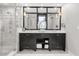 Bathroom vanity with double sinks, dark wood cabinets, and large mirror at 470 Manor Rd, Maitland, FL 32751