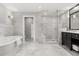 Bright bathroom featuring soaking tub, glass shower, and elegant marble accents at 470 Manor Rd, Maitland, FL 32751