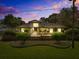 Serene home exterior at dusk with lush landscaping and warm, inviting lighting at 470 Manor Rd, Maitland, FL 32751