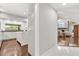 Hallway view into the kitchen and living room with a white tiled floor and modern decor at 470 Manor Rd, Maitland, FL 32751