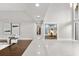 Bright hallway with tile flooring leads past a sitting room and into the dining room at 470 Manor Rd, Maitland, FL 32751