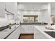 Contemporary kitchen with sleek white cabinets, counter-to-ceiling window, and stainless steel appliances at 470 Manor Rd, Maitland, FL 32751