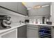 Gray kitchenette including a wine fridge, small appliances, and white countertops at 470 Manor Rd, Maitland, FL 32751