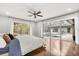 Main bedroom with wood floors, ceiling fan, and sliding doors to the swimming pool at 470 Manor Rd, Maitland, FL 32751