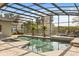 A screened-in pool and spa with a beautiful stone deck and plenty of room for lounging at 470 Manor Rd, Maitland, FL 32751