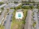 Overhead shot of condominium complex showcasing pool, parking, multiple units, and mature trees at 4705 S Texas Ave # 4705D, Orlando, FL 32839