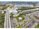 Aerial view of complex with pool, landscaping, parking, roadways, lake and nearby commercial buildings at 4705 S Texas Ave # 4705D, Orlando, FL 32839