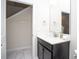 Modern bathroom featuring a stylish vanity and an additional storage closet at 4844 Romeo Cir, Kissimmee, FL 34746