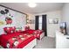 Whimsical bedroom with two twin beds and vibrant red Mickey Mouse themed bedding and decor at 4844 Romeo Cir, Kissimmee, FL 34746