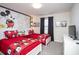 Whimsical bedroom with two twin beds and vibrant red Mickey Mouse themed bedding and decor at 4844 Romeo Cir, Kissimmee, FL 34746