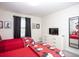 Bright bedroom featuring two beds with red Mickey Mouse bedding, a TV, and black-out curtains at 4844 Romeo Cir, Kissimmee, FL 34746