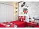 This charming bedroom features a Mickey Mouse theme, with artwork, bedding, and a fun desk setup at 4844 Romeo Cir, Kissimmee, FL 34746