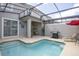 An inviting swimming pool with lounge chairs, a grill, and outdoor dining beneath a screened enclosure at 4844 Romeo Cir, Kissimmee, FL 34746