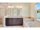 Luxurious bathroom with a soaking tub, separate shower, and dual sink vanity at 5023 Southlawn Ave, Orlando, FL 32811