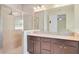 Bathroom featuring double vanity with granite countertops, framed mirror, and glass shower at 5023 Southlawn Ave, Orlando, FL 32811