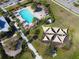 Aerial view of community pool, splashpad, playground, cabanas, and clubhouse at 5023 Southlawn Ave, Orlando, FL 32811